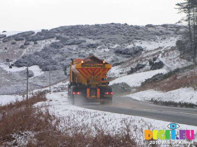 SX12146 Gritting truck driving through hillsides covered in snow